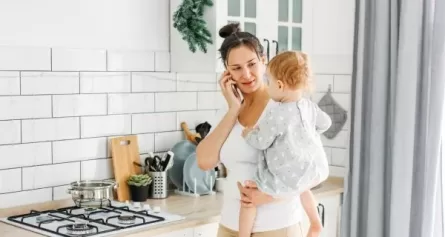 Mom talking on phone while holding child