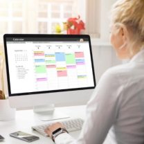 Woman sitting at her computer looking through the events calendar.