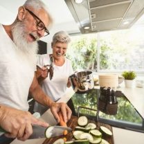 Two seniors cooking together having fun